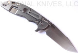Rick Hinderer Knives XM-18 3.5" Harpoon Spanto folding knife with thumb stud and flipper tab - shown open lock side.  Stonewash 20CV stainless steel plain edge blade.  OD green - black G-10 handle with stonewash lock side.  Model K2552SGS00.