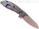 Rick Hinderer Knives XM-24 Sheepsfoot folding knife with thumb stud and flipper tab - shown open lock side.  Working Finish 20CV stainless steel plain edge blade.  Blue - black G-10 handle with Battle Blue lock side.  Model K3073SGW00.

