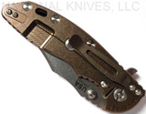 Rick Hinderer Knives XM-18 3.5" Bowie folding knife with thumb stud and flipper tab - shown closed lock side.  Stonewash 20CV stainless steel plain edge blade.  OD green - black G-10 handle with stonewash bronze titanium lock side.  Model K2032SGS00.
