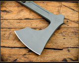 RMJ Tactical 3V Syndicate Raven tomahawk - shown close up of head out of sheath obverse.  Jungle Green Cerakote CPM-3V steel plain edge head.  Black G-10 handle.
For reference only.