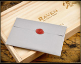 RMJ Tactical 3V Syndicate Raven tomahawk - wood box and 3V Syndicate envelope shown.  Jungle Green Cerakote CPM-3V steel plain edge head.  Black G-10 handle.
For reference only.