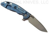 Rick Hinderer Knives XM-18 3.5" Spanto folding knife with thumb stud and flipper tab - shown open lock side.  Working Finish S45VN stainless steel plain edge blade.  Blue G-10 handle with Battle Blue lock side.  Model K2002SGW00.