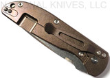 Rick Hinderer Knives Firetac Recurve folding knife with thumb disk - shown closed lock side.  Stonewash 20CV stainless steel plain edge blade.  OD green G-10 handle with stonewash bronze lock side.  Model K205FSGS00.