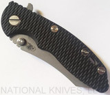 Rick Hinderer Knives XM-18 3.0" Skinner folding knife with thumb studs and flipper tab - shown closed presentation side.  Working Finish 20CV stainless steel plain edge blade.  Black G-10 handle with Working Finish lock side.  Model K1041SGW00.