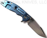 Rick Hinderer Knives Skinny XM-18 3.5" Harpoon Spanto folding knife with thumb stud and flipper tab - shown open lock side.  Stonewash 20CV stainless steel plain edge blade.  Black G-10 handle with stonewash blue lock side.  Model K2555SGS00.