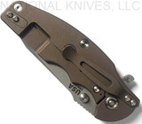 Rick Hinderer Knives Jurassic Spear Point folding knife with thumb stud and flipper tab - shown closed lock side.  Working Finish 20CV stainless steel plain edge blade.  OD green G-10 handle with Battle Bronze lock side.  Model K208JSGW00.
