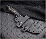 RMJ Tactical Ratatosk fixed blade knife - shown in sheath obverse.  Cobalt Cerakote Nitro-V stainless steel plain edge blade.  Black carbon fiber handle.