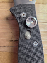 Used Spyderco Autonomy 2 automatic knife with button blade release - close up of button lock shown in unlocked position with blade open.  Satin LC200N plain edge blade.  Black G-10 handle.  Model C165GP2.