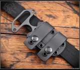 RMJ Tactical BUB fixed blade knife - shown obverse in sheath.  Cobalt Cerakote S45VN stainless steel double plain edge blade.  
