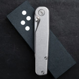 Tactile Knife Co Rockwall folding knife with a thumb stud - shown closed presentation side.  Stonewashed MagnaCut stainless steel plain edge blade.  Titanium handle.  Model 20-RT-MC01-TT01.