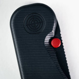 Tactile Knife Co Seasonal Release Stealth folding knife with thumb stud - shown close up of pivot.  Black MagnaCut stainless steel plain edge blade.  Stealth themed titanium handle.