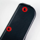 Tactile Knife Co Seasonal Release Stealth folding knife with thumb stud - shown close up of handle screws.  Black MagnaCut stainless steel plain edge blade.  Stealth themed titanium handle.