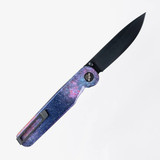 Tactile Knife Co Seasonal Release Deep Space Rockwall folding knife with thumb stud - shown open pocket clip side.  Black MagnaCut stainless steel plain edge blade.  Deep Space themed titanium handle.
For reference only.