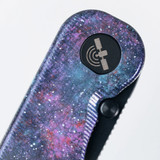 Tactile Knife Co Seasonal Release Deep Space Rockwall folding knife with thumb stud - shown close up of pivot.  Black MagnaCut stainless steel plain edge blade.  Deep Space themed titanium handle.
For reference only.
