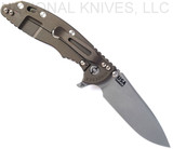 Rick Hinderer Knives Skinny XM-18 3.5" Slicer folding knife with thumb stud and flipper tab - shown open lock side.  Working Finish MagnaCut stainless steel plain edge blade.  Translucent Green G-10 handle with Battle Bronze lock side.  Model KXM35SKSL.