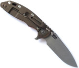Rick Hinderer Knives Skinny XM-18 3.5" Slicer folding knife with thumb stud and flipper tab - shown open lock side.  Working Finish MagnaCut stainless steel plain edge blade.  Red G-10 handle with Battle Bronze lock side.  Model KXM35SKSL.