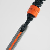 Tactile Knife Co 8-Bit Bexar limited edition slip joint knife with nail nick - close up of lanyard top view.  Black MagnaCut stainless steel plain edge blade.  Gray and orange titanium handle.  Model 20-BX-MCDL-TTDL
For reference only.