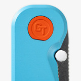 Tactile Knife Co Seasonal Release GT Rockwall folding knife with a thumb stud - close up of pivot and thumb stud.  Stonewashed MagnaCut stainless steel plain edge Tanto blade.  Blue coated titanium handle.  Model 20-RT-MCTN-TTGT.
