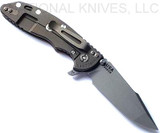 Rick Hinderer Knives XM-18 3.5" Harpoon Spanto folding knife with thumb stud and flipper tab - shown open lock side.  Working Finish S45VN stainless steel plain edge blade.  
FDE G-10 handle with Battle Bronze lock side.  Model KXM35HS.