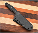 RMJ Tactical Osprey 9 Adventure kitchen knife - shown in sheath obverse.  14C28N stainless steel plain edge blade.  Black G-10 handle.  Model K-OSP9-SW-BK