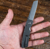 Tactile Knife Co Mariner 2 folding knife with thumb disk - shown open in hand pocket clip side.  Stonewash MagnCut stainless steel plain edge blade. Titanium handle.  Model 20-MAR-MC01-TUTT