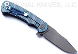 Rick Hinderer Knives Project X Clip Point folding knife with flipper tab - shown open lock side.  Stonewash S45VN stainless steel plain edge blade.  Black G-10 handle with stonewash blue lock side.  Model KPXSPE.