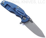 Rick Hinderer Knives Jurassic Hollow Grind Slicer folding knife with flipper tab - shown open lock side.  Working Finish MagnaCut stainless steel plain edge blade.  Translucent Green G-10 handle scale with Battle Blue titanium lock side.  Model KJURSLHO.