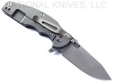 Rick Hinderer Knives Jurassic Hollow Grind Slicer folding knife with flipper tab - shown open lock side.  Working Finish MagnaCut stainless steel plain edge blade.  Blue - Black G-10 handle scale with Working Finish titanium lock side.  Model KJURSLHO.
