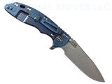 Rick Hinderer Knives XM-18 Skinny Slicer with thumb stud and flipper tab - shown open lock side.  Stonewash Magnacut stainless steel, hollow ground, plain edge blade.  Red G-10 handle with stonewash blue lock side. 