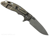 Rick Hinderer Knives XM-18 Skinny Slicer with thumb stud and flipper tab - shown open lock side.  Working Finish Magnacut stainless steel, hollow ground, plain edge blade.  Coyote Brown G-10 handle with Battle Bronze lock side. 