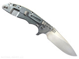Rick Hinderer Knives XM-18 Skinny Slicer with thumb stud and flipper tab - shown open lock side.  Stonewash Magnacut stainless steel, hollow ground, plain edge blade.  Translucent Green G-10 handle with stonewash lock side. 