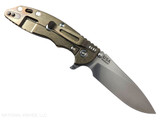 Rick Hinderer Knives XM-18 Skinny Slicer with thumb stud and flipper tab - shown open pocket clip side.  Stonewash Magnacut stainless steel, hollow ground, plain edge blade.  Coyote Brown G-10 handle with stonewash bronze lock side. 