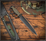 RMJ Tactical Lady Death fixed blade knife - shown out of sheath obverse with sheath in background.  Graphite Black Cerakote 3V steel plain edge blade.  Dirty Olive G-10 handle.  Model K-LD-3V-GB-DO-BW.