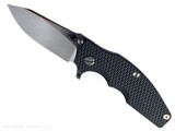 Rick Hinderer Knives Jurassic Hollow Grind Slicer folding knife with flipper tab - shown open presentation side. Stonewash MagnaCut stainless steel plain edge blade. Black G-10 handle scale with stonewash titanium lock side. Model KJURSLHO. Rick Hinderer Knives Jurassic Hollow Grind Slicer folding knife with flipper tab - shown open presentation side. Stonewash MagnaCut stainless steel plain edge blade. Black G-10 handle scale with stonewash titanium lock side. Model KJURSLHO.