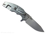 Rick Hinderer Knives Jurassic Hollow Grind Slicer folding knife with flipper tab - shown open lock side.  Stonewash MagnaCut stainless steel plain edge blade.  Black G-10 handle scale with stonewash titanium lock side.  Model KJURSLHO.