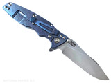 Rick Hinderer Knives Skinny Eklipse Slicer folding knife with flipper tab - shown open - lock side.  Stonewash 3.5" hollow grind MagnaCut stainless steel plain edge blade.  OD green G-10 handle scale with stonewashed blue lock side.  Model KEK35SKSLHO