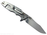 Rick Hinderer Knives Skinny Eklipse Slicer folding knife with flipper tab - shown open - lock side.  Stonewash 3.5" hollow grind MagnaCut stainless steel plain edge blade.  Blue G-10 handle scale with stonewash lock side.  Model KEK35SKSLHO