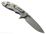 Rick Hinderer Knives XM-18 3.5" Spanto folding knife with thumb stud and flipper tab - shown open lock side.  Working Finish 20CV stainless steel plain edge blade.  Blue - black G-10 handle with Working Finish lock side.  Model KXM35SPA.