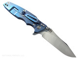 Rick Hinderer Knives Skinny Eklipse Slicer folding knife with flipper tab - shown open - lock side.  Stonewash 3.5" hollow grind MagnaCut stainless steel plain edge blade.  Blue - black G-10 handle scale with stonewash blue lock side.  Model KEK35SKSLHO Rick Hinderer Knives Skinny Eklipse Slicer folding knife with flipper tab - shown open - lock side.  Stonewash 3.5" hollow grind MagnaCut stainless steel plain edge blade.  Blue - black G-10 handle scale with stonewash blue lock side.  Model KEK35SKSLHO