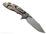 Rick Hinderer Knives XM-18 Skinny Harpoon Spanto with thumb stud and flipper tab - shown open lock side.  Working Finish MagnaCut stainless steel plain edge blade.  Orange G-10 handle with Battle Bronze lock side.  Model KXM35SKHS. Rick Hinderer Knives XM-18 Skinny Harpoon Spanto with thumb stud and flipper tab - shown open lock side.  Working Finish MagnaCut stainless steel plain edge blade.  Orange G-10 handle with Battle Bronze lock side.  Model KXM35SKHS.