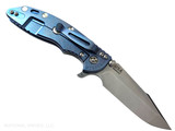 Rick Hinderer Knives XM-18 Skinny Harpoon Spanto with thumb stud and flipper tab - shown open lock side.  Stonewash MagnaCut stainless steel plain edge blade.  Translucent Green G-10 handle with stonewash blue lock side.  Model KXM35SKHS. Rick Hinderer Knives XM-18 Skinny Harpoon Spanto with thumb stud and flipper tab - shown open lock side.  Stonewash MagnaCut stainless steel plain edge blade.  Translucent Green G-10 handle with stonewash blue lock side.  Model KXM35SKHS.