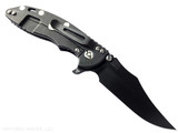 Rick Hinderer Knives XM-18 3.5" Bowie folding knife with thumb stud and flipper tab - shown open lock side.  Battle Black MagnaCut stainless steel plain edge blade.  Black G-10 handle with Battle Black lock side.  Model KXM35BOWMC.