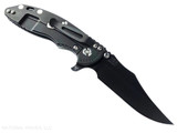 Rick Hinderer Knives XM-18 3.5" Bowie folding knife with thumb stud and flipper tab - shown open lock side.  Battle Black MagnaCut stainless steel plain edge blade.  Translucent Green G-10 handle with Battle Black lock side.  Model KXM35BOWMC.