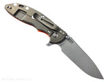 Rick Hinderer Knives XM-18 3.5" Slicer Hollow Grind folding knife with thumb stud and flipper tab - shown open lock side.  Working Finish 20CV stainless steel plain edge blade.  Orange G-10 handle with Battle Bronze lock side.  Model KXM35SLHO.