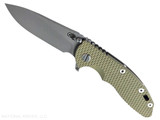 Rick Hinderer Knives XM-18 3.5" Slicer Hollow Grind folding knife with thumb stud and flipper tab - shown open presentation side.  Working Finish 20CV stainless steel plain edge blade.  OD green G-10 handle with Battle Bronze lock side.  Model KXM35SLHO.