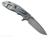 Rick Hinderer Knives XM-18 3.25" Spear Point folding knife with thumb stud and flipper tab - shown open lock side.  Stonewash S45VN stainless steel plain edge blade.  Blue G-10 handle with stonewash lock side.  Model KXM325SPE.