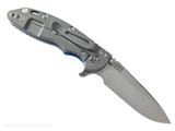 Rick Hinderer Knives XM-18 3.25" Spear Point folding knife with thumb stud and flipper tab - shown open lock side.  Stonewash S45VN stainless steel plain edge blade.  Blue G-10 handle with Working Finish lock side.  Model KXM325SPE.