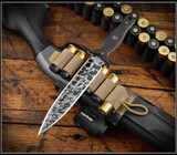 RMJ Tactical Kilroy fixed blade knife - shown out of sheath obverse.  Acid Etched with black Cerakote Resist Camo M390 steel, double plain edge, blade.  Black G-10 handle scales. Model K-KRY-M390-CAE-BLK.