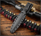 RMJ Tactical Kilroy fixed blade knife - shown in sheath obverse.  Acid Etched with black Cerakote Resist Camo M390 steel, double plain edge, blade.  Black G-10 handle scales. Model K-KRY-M390-CAE-BLK.