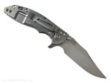 Rick Hinderer Knives XM-18 3.0" Bowie folding knife with thumb stud and flipper tab - shown open lock side.  Stonewash 20CV stainless steel plain edge blade.  OD green G-10 handle with stonewashed lock side.  Model KXM30BOW.